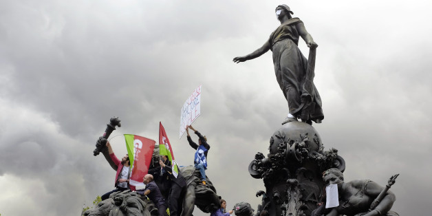 Union activists attend May Day celebrations, in Paris, Thursday May 1, 2014. Tens of thousands of workers marked May Day in European cities with a mix of anger and gloom over austerity measures imposed by leaders trying to contain the eurozone's intractable debt crisis. (AP Photo/Jerome Delay)