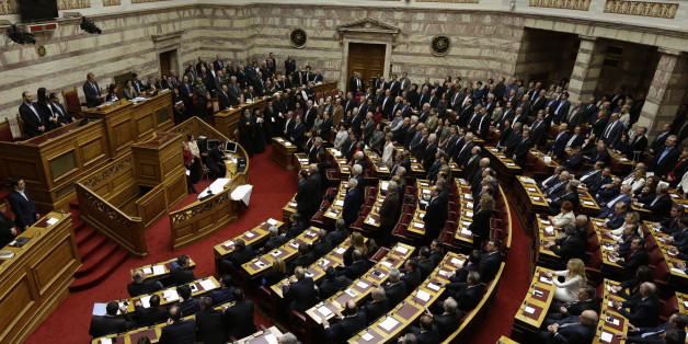 Lawmakers elected in Greece's Jan. 25 national elections are sworn in taking a secular oath at the first convention of Parliament since the elections in Athens on Thursday, Feb. 5, 2015. Non Greek Orthodox lawmakers were sworn in with a secular, or Muslim version of the oath. Jittery investors dumped Greek shares Thursday after the European Central Bank tightened the screws on the country's banking system, piling pressure on the new anti-austerity government to seek a compromise with bailout creditors. (AP Photo/Thanassis Stavrakis)