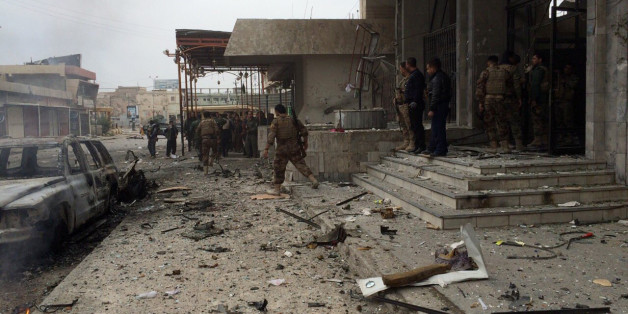 Kurdish peshmerga fighters secure a hotel near police headquarters in oil-rich Kirkuk, 290 kilometers (180 miles) north of Baghdad, Iraq, Friday, Jan. 30, 2015. Kurdish troops and the cityâs security force have been trying to rout militants from the Islamic State group after three gunmen took positions inside the hotel, located in the city center, triggering a firefight with Kurdish fighters and the police. (AP Photo)