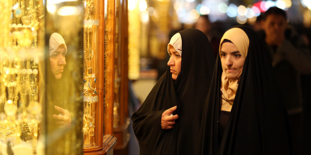 In this Thursday, Jan. 8, 2015 photo, people shop at a jewelry shop in the holy city of Najaf, 100 miles (160 kilometers) south of Baghdad, Iraq. Since Sunni militants of the Islamic State group overran large parts of Iraq, the country's most prominent Shiite cleric has fundamentally altered his spiritual role and has plunged straight into politics, weighing in to the government on policy and on fighting the extremists. (AP Photo/Hadi Mizban)