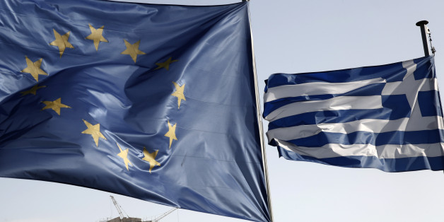 A Greek and a European Union flag billow in the wind as the ruins of the fifth century BC Parthenon temple is seen in the background on the Acropolis hill, in Athens, Friday, Jan. 23, 2015. Prime Minister Antonis Samaras' New Democracy party has failed so far to overcome a gap in opinion polls with the anti-bailout Syriza party ahead of the Jan. 25 general election. (AP Photo/Petros Giannakouris)
