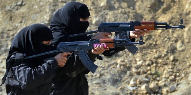 Pakistani policewomen demonstrate their skills during a special elite police training course at a police training centre in Nowshera, a district in the Khyber Pakhtunkhwa Province on February 11, 2015. Dozens of male and female police took part in a commando training course, introduced by the local police as an additional skill for the police to be deployed to confront terrorism and extremism which is routinely on the rise in this South Asian nuclear-armed country. AFP PHOTO / A MAJEED (Photo credit should read A Majeed/AFP/Getty Images)
