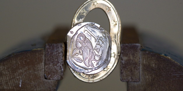 GERMANY, BONN - FEBRUARY 12: Squashed Greek 1 Euro coin in a vice, on February 12, 2015 in Bonn, Germany. (Photo by Ulrich Baumgarten via Getty Images)