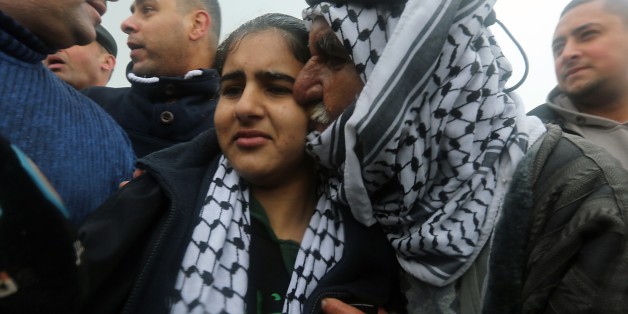 Palestinian 14-year-old schoolgirl Malak al-Khatib is greeted by her father after her release from an Israeli jail on February 13, 2015, in the West Bank Palestinian town of Tulkarem. Israel freed Malak, whose jailing six weeks ago for planning to attack Israelis became a focus for anger over the arrest of children in the occupied territories. Malak was arrested on her way home from school on December 31, and a military court subsequently jailed her for two months. According to the indictment sh