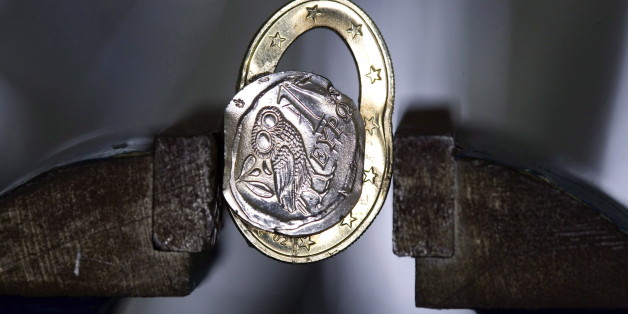 GERMANY, BONN - FEBRUARY 12:Â Squashed Greek 1 Euro coin in a vice, on February 12, 2015 in Bonn, Germany. (Photo by Ulrich Baumgarten via Getty Images)