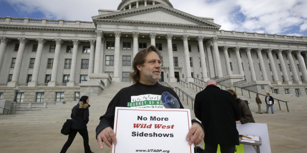 FILE - In this Jan. 27, 2015, file photo, Randy Gardner of Salt Lake City, the older brother of Ronnie Lee Gardner, the last inmate to be killed by firing squad in Utah in 2010, protests with a group opposed to capital punishment plans over one lawmaker's plan to resurrect the use of firing squads, outside the Utah State Capitol, in Salt Lake City. A controversial proposal that resurrects Utah's use of firing squads to carry out executions has advanced in the state legislature by a handful of votes. (AP Photo/Rick Bowmer, File)