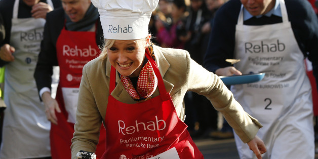 Media team competitor Sophie Ridge flips a pancake as she competes during the 2015 Parliamentary Pancake Race, Tuesday, Feb. 17, 2015. The race saw Lords, MPs and members of the parliamentary press corps racing to raise awareness of the need to support disable people, according to the organizers. (AP Photo/Lefteris Pitarakis)