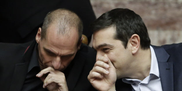 Greece's Prime Minister Alexis Tsipras chats with Greece's Finance Minister Yanis Varoufakis during a Presidential vote in Athens, on Wednesday, Feb. 18, 2015. Greeceâs parliament has elected conservative law professor and veteran politician Prokopis Pavlopoulos as the countryâs next president, after he received support from the new left-wing government and main center-right opposition party.(AP Photo/Petros Giannakouris)
