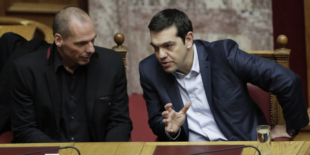 Greece's Prime Minister Alexis Tsipras, right, and Finance Minister Yanis Varoufakis talk during a Presidential vote in Athens, on Wednesday, Feb. 18, 2015. Greece's parliament elected a conservative law professor and veteran politician Wednesday as the country's new president, after he received support from the new left-wing government and main center-right opposition party. (AP Photo/Petros Giannakouris)