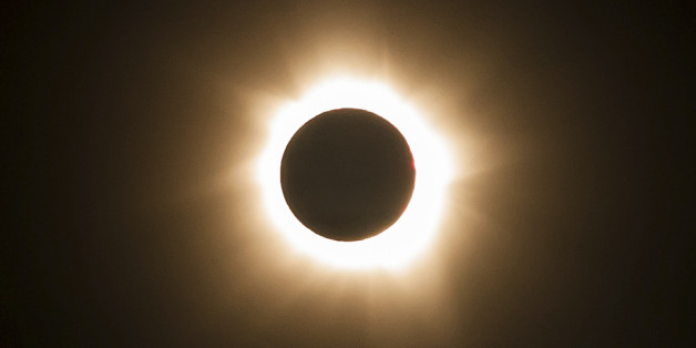 In this photo provided by Tourism Queensland, the moment of a total solar eclipse is observed at Cape Tribulation in Queensland state, Australia, Wednesday, Nov. 14, 2012. Starting just after dawn, the eclipse cast its 150-kilometer (95-mile) shadow in Australia's Northern Territory, crossed the northeast tip of the country and was swooping east across the South Pacific, where no islands are in its direct path. (AP Photo/Tourism Queensland) EDITORIAL USE ONLY