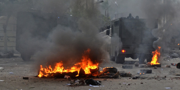 Egyptian security forces try to disperse supporters of Egypt's ousted President Mohammed Morsi protesting against the government in Cairo, Egypt, Friday, Jan. 31, 2014. Around the country, riot police firing tear gas clashed with hundreds of Morsi supporters protesting in Cairo, the Mediterranean coastal city of Alexandria and Fayoum, south of the capital. The Egyptian military also battled Islamic militants in the northern part of Sinai who have escalated a campaign of bombings and shootings in retaliation for last summer's army coup that ousted Morsi and for the ensuing crackdown against Islamists. (AP Photo/Mostafa Darwish)