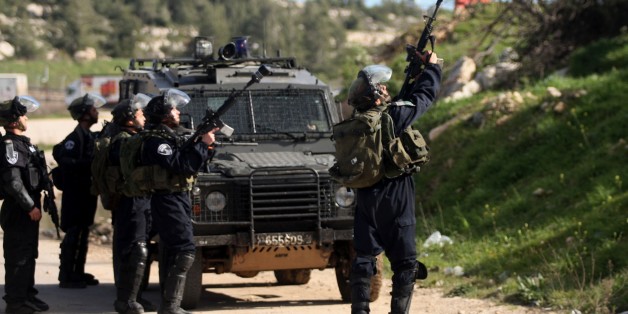 RAMALLAH WEST BANK - FEBRUARY 28: Israeli Security Forces use tear gas and plastic bullets against Palestinians group, includes mostly students from Birzeit University during the clashes after the demonstration staged to support Palestinian prisoners arrested by Israel, near the Israeli Ofer Prison in Ramallah, West Bank on February 28, 2015. (Photo by Shadi Hatem/Anadolu Agency/Getty Images)