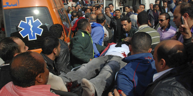 A wounded man is evacuated from the site of an explosion in a crowded area near the Egyptian High Court, in downtown Cairo, Egypt, Monday, March 2, 2015. Egyptian state TV says a midday bomb blast in downtown Cairo wounded several people. Egypt has seen a series of attacks mainly targeting security forces since the military ousted Islamist President Mohammed Morsi in the summer of 2013. The attacks have raised fears ahead of an economic conference later this month aimed at attracting foreign inv