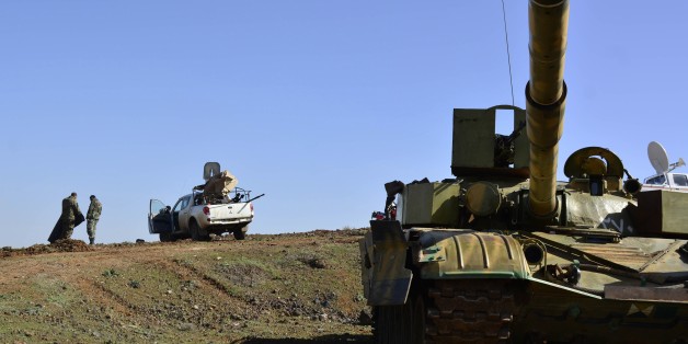 Syrian government forces gather on the Fatima hill overlooking the town of Kfar Shams, north of the southern Syrian city of Deraa on March 1, 2015, after they regained control of the hill the day before. AFP PHOTO / STR (Photo credit should read STR/AFP/Getty Images)