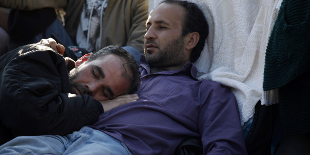 Syrian refugees on a hunger strike, rest under a makeshift tent at central Syntagma square, outside the Greek parliament in Athens on Sunday, Dec. 14 2014. About 150 Syrian civil war refugees began a hunger strike in front of Greece's Parliament three weeks ago, urging the government to grant them temporary working and residence rights. Greece is a busy entry point for immigrants and refugees seeking entry to the European Union. The financial crisis-hit country has seen a spike in the number of Syrians crossing by boat illegally from nearby Turkey. (AP Photo/Kostas Tsironis)