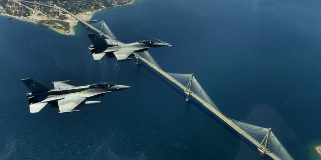 FILE -- In this file photo, a pair of F16 fighters of the Greek airforce fly over the Rio-Antirio bridge in Northwest Peloponnese on Wednesday May 26, 2010. Two similar Greek fighter jets crashed in mid-air during a training exercise south of the island of Crete on Thursday, killing one of the three crew members and leaving the other two injured, the air force said. The F-16 planes - one a single-seater and one a double-seater - had been part of a formation of four planes on a training mission w