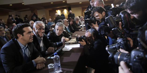 Greek Prime Minister and Syriza leader Alexis Tsipras, left, attends his party central committee, in Athens, on Saturday, Feb. 28, 2015. Greece's new radical left government has no intention of seeking yet another bailout deal from international creditors and will spend coming months trying to ease the terms of its current commitments, the financially struggling country's prime minister said Friday.(AP Photo/Petros Giannakouris)