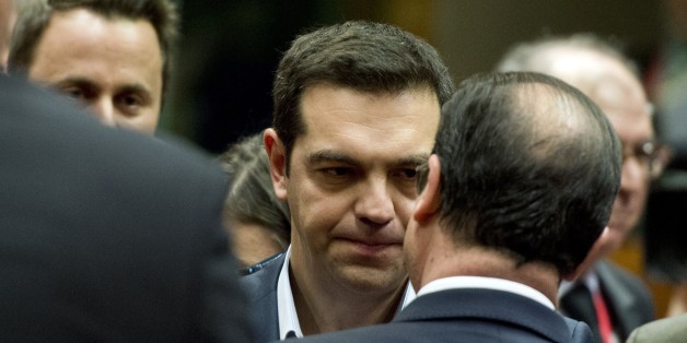 Greek Prime Minister Alexis Tsipras (L) speak with French President Francois Hollande before a round table meeting as part of the European Council Summit at the European Union (EU) Headquarters in Brussels on February 12, 2015. AFP PHOTO/ ALAIN JOCARD (Photo credit should read ALAIN JOCARD/AFP/Getty Images)