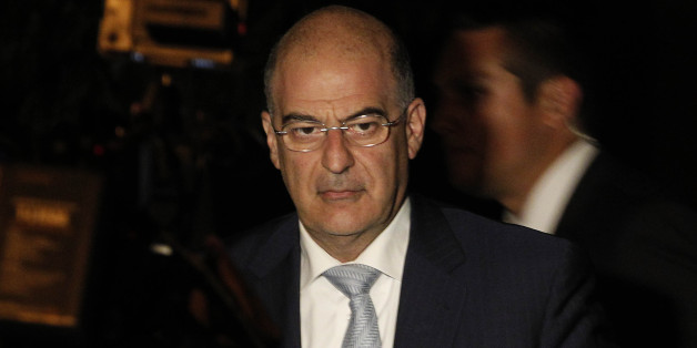 Minister of Public Order and Citizen Protection, Nikolaos Dendias arrives for an urgent cabinet meeting at the Prime minister's office in Athens, on Thursday, June 20, 2013. The fate of Greeceâs shaky coalition government is hanging in the balance after talks over the closure of state TV collapsed. Conservative Prime Minister Antonis Samarasâ surprise move to shut down state ERT broadcaster last week, to save money, sparked protests in Greece and abroad and angered both his center-left allies.(AP Photo/Petros Giannakouris)