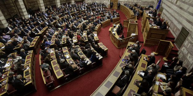 Greek lawmakers take part in a parliament session to vote for president in Athens, on Wednesday, Feb. 18, 2015. Greece's parliament elected a conservative law professor and veteran politician Wednesday as the country's new president, after he received support from the new left-wing government and main center-right opposition party. (AP Photo/Petros Giannakouris)