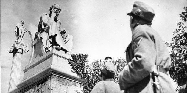German troopers in their field grey uniforms look up at two ancient Greek statues on the Acropolis in Athens, Greece on June 15, 1941 during World War II. The statue in front is of Greek philosopher Socrates. (AP Photo)