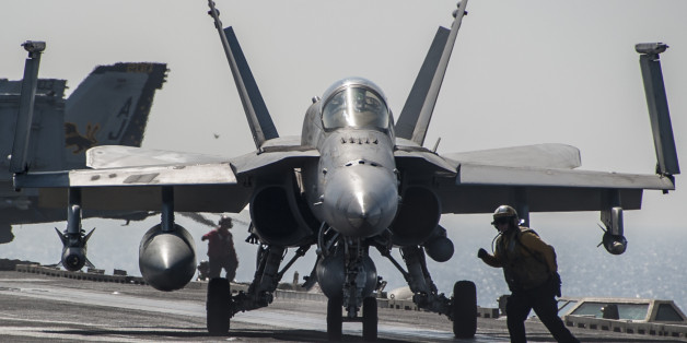 ARABIAN GULF (Oct. 4, 2014) An F/A-18C Hornet, attached to the "Valions" of Strike Fighter Squadron (VFA) 15, taxis on the flight deck of the aircraft carrier USS George H.W. Bush (CVN 77). George H.W. Bush is supporting maritime security operations, strike operations in Iraq and Syria as directed, and theater security cooperation efforts in the U.S. 5th Fleet area of responsibility. (U.S. Navy photo by Mass Communication Specialist 3rd Class Brian Stephens/Released)