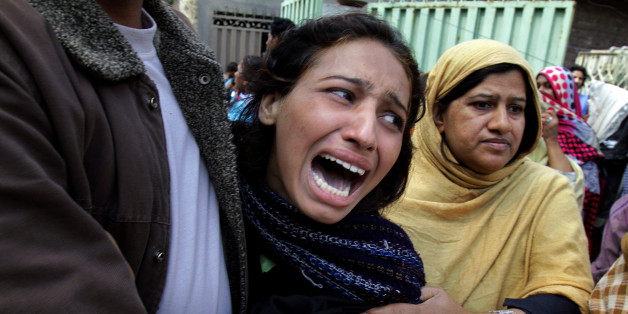A Pakistani Christian woman mourns over a family member who was killed from a suicide bombing attack near two churches in Lahore, Pakistan, Sunday, March 15, 2015. Suicide bombers exploded themselves near two churches in the eastern city of Lahore on Sunday as worshippers were gathered inside, killing at least a dozen people, officials said, in the latest attack against religious minorities in the country. (AP Photo/K.M. Chaudary)
