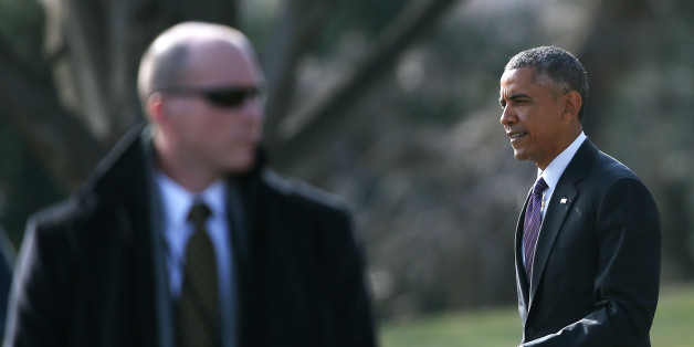 WASHINGTON, DC - JANUARY 15: A Secret Service agent stands guard as President Barack Obama walks to Marine One while departing the White House January 15, 2015 in Washington, DC. President Obama is traveling to Baltimore MD. to meet with Senate Democrats during a private strategy retreat. (Photo by Mark Wilson/Getty Images)