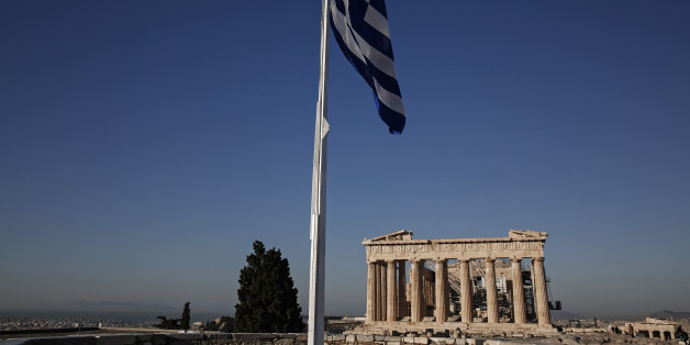 A Greek national flag flies near the Parthenon temple on Acropolis Hill in Athens, Greece, on Saturday, Feb. 21, 2015. Greece obtained a provisional deal from euro-area finance ministers intended to keep aid flowing to the country in return for oversight on fiscal measures, buying time to work out the detail of longer-term Greek financing. Photographer: Yorgos Karahalis/Bloomberg via Getty Images