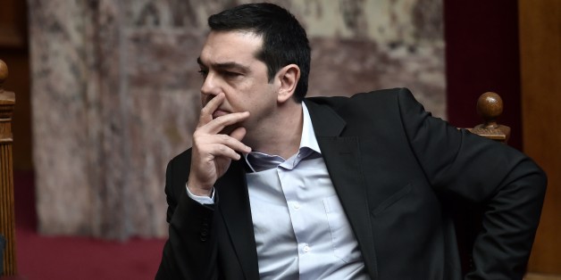 Greek Prime Minister Alexis Tsipras sits on March 18, 2015 in the parliament in Athens. Greece was responding sharply to apparent pressure from the EU not to pass a so-called 'humanitarian crisis' law that would provide free electricity and food stamps for the poorest households. AFP PHOTO / ARIS MESSINIS (Photo credit should read ARIS MESSINIS/AFP/Getty Images)
