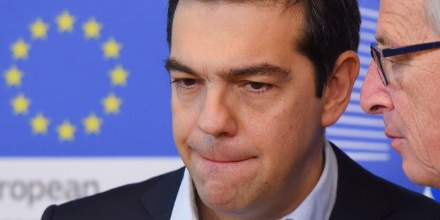 Greece's Prime Minister Alexis Tsipras (C) is welcome by European Commission President Jean-Claude Juncker at the European Commission in Brussels on March 13, 2015. Tsipras is in Brussels for talks on Athens' debt-hit bailout. AFP PHOTO / Emmanuel Dunand (Photo credit should read EMMANUEL DUNAND/AFP/Getty Images)