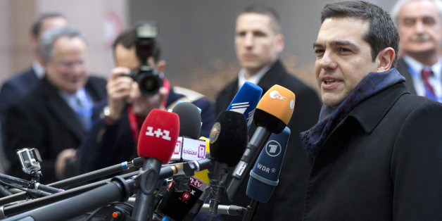 Greek Prime Minister Alexis Tsipras, second right, speaks with the media as he arrives for an EU summit in Brussels on Thursday, Feb. 12, 2015. European Union leaders on Thursday said the full respect of the planned weekend cease-fire in eastern Ukraine will be essential before there could be a change in the sanctions regime imposed on Moscow. (AP Photo/Virginia Mayo)