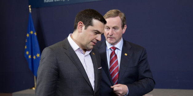 Irish Prime Minister Enda Kenny, right, speaks with Greek Prime Minister Alexis Tsipras after a group photo at an EU summit in Brussels on Thursday, March 19, 2015. Tensions over Greece's massive financial bailout overshadowed a European Union summit amid fears that the country could accidentally drop out of the euro, triggering a crisis across the currency zone shared by 19 nations. (AP Photo/Francois Mori)