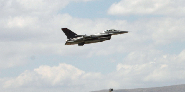 A Turkish F-16 prepares to taxi while another one takes off during Anatolian Eagle exercise at 3rd Main Jet Air Base near the central Anatolian city of Konya, Turkey, Monday, June 15, 2009. Dozens of U.S., British and Turkish pilots are engaging in mock aerial battles over central Turkey, indicating deepening relations between the allies. Pilots from Jordan and the United Arab Emirates are also participating in the exercise. (AP Photo/Selcan Hacaoglu)