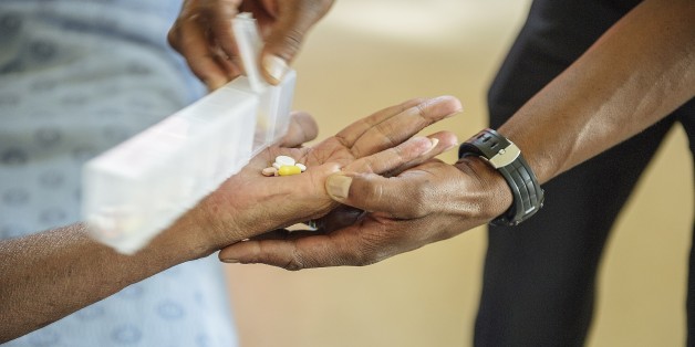 Former Tuberculosis affected patient Ashley McQuire receives his medication from a nurse at the Tshepong Hospital Tubercolosis ward on March 12, 2015 in Klerksdorp. He is one of the first patients to have survived Extra Drugs Resistant (XDR) TB and he will leave the facility at the end of March. AFP PHOTO / MUJAHID SAFODIEN (Photo credit should read MUJAHID SAFODIEN/AFP/Getty Images)