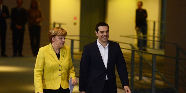 German Chancellor Angela Merkel (L) and Greek Prime Minister Alexis Tsipras arrive to address a press conference following talks at the chancellery in Berlin, on March 23, 2015. AFP PHOTO / JOHN MACDOUGALL (Photo credit should read JOHN MACDOUGALL/AFP/Getty Images)