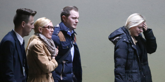 Crying people arrive at the airport in Duesseldorf, Germany, Tuesday, March 24, 2015, after a Germanwings passenger jet carrying more than 140 people crashed in the French Alps region as it traveled from Barcelona to Duesseldorf. (AP Photo/Frank Augstein)