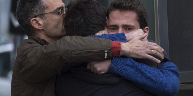 Family members of people involved in a crashed plane comfort each other as they arrive at the Barcelona airport in Spain, Tuesday, March 24, 2015. A Germanwings passenger jet carrying more than 140 people crashed in the French Alps region as it traveled from Barcelona to Duesseldorf in Germany. (AP Photo/Emilio Morenatti)