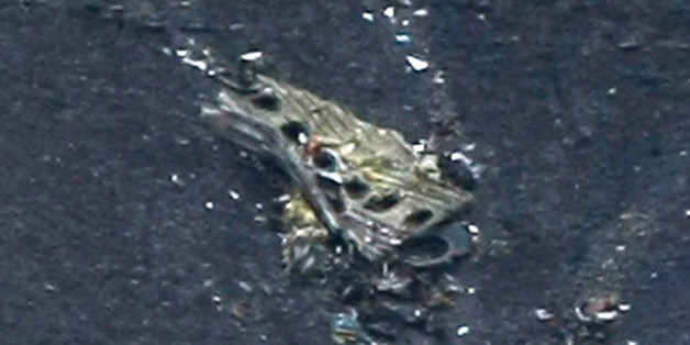 Debris of the crashed Germanwings passenger jet is scattered on the mountain side near Seyne les Alpes, French Alps, Tuesday, March 24, 2015. The Germanwings passenger jet carrying at least 150 people crashed Tuesday in a snowy, remote section of the French Alps, sounding like an avalanche as it scattered pulverized debris across the mountain. (AP Photo/Claude Paris)