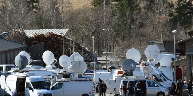 Journalists wait on March 26, 2015 on an air base in Seyne-les-Alpes, French Alps two days after a Germanwings Airbus A320 smashed into the French Alps, killing all 150 people on board. One of the two pilots on the Germanwings flight that crashed in the French Alps was locked out of the cockpit before the plane went down, killing 150 people, a source close to the investigation told AFP on March 26. All 150 people on board, including two babies and 16 German school exchange pupils, died when the