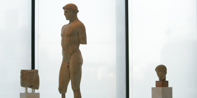 A 2,600-year-old marble statue of a youth is displayed in the new Acropolis Museum in Athens, Greece, on Wednesday, June 17, 2008. Greece's Orthodox Church on Wednesday formally blessed the new museum, which is scheduled to open this weekend. Greek officials hope one day to display the British Museum's Elgin Marbles from the Acropolis in the glass and concrete museum _ despite repeated refusals from London.(AP Photo/Petros Giannakouris)