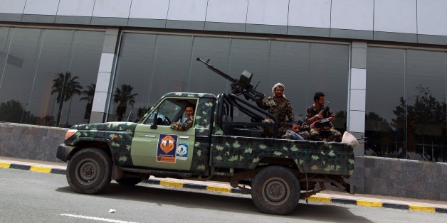 Armed member of Shiite Huthi militia, wearing military fatigue, patrol the Sanaa International Airport in Sanaa, on March 28, 2015 after the third day of Saudi-led coalition airstrikes against Huthis. At least 200 UN staff and other expatriates were evacuated from the Yemeni capital, as an Arab coalition pressed a bombing campaign against Shiite rebels in the city, aid workers said. AFP PHOTO / MOHAMMED HUWAIS (Photo credit should read MOHAMMED HUWAIS/AFP/Getty Images)