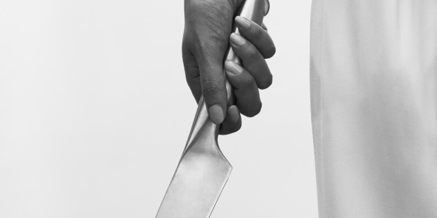 Man's hand holding large hand gun, close up