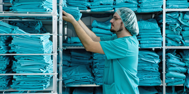 Stacking shelves with scrubs in hospital laundry