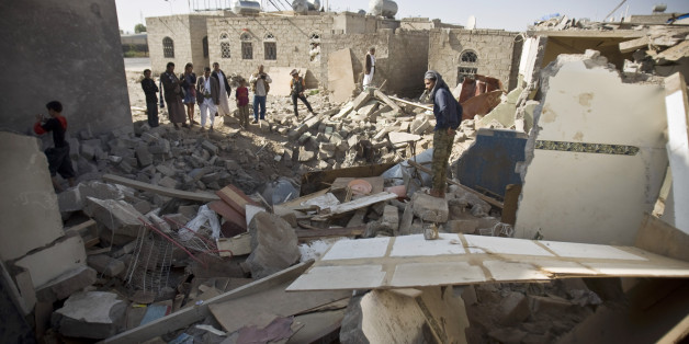 Yemenis gather near the rubble of houses destroyed by Saudi airstrikes near the airport in Sanaa, Yemen, Tuesday, March 31, 2015. (AP Photo/Hani Mohammed)