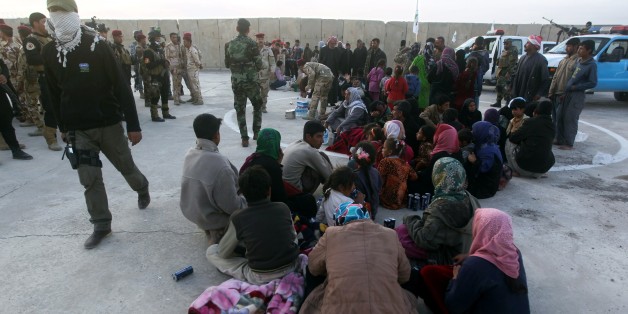 Displaced Iraqi Sunni families who fled the villages of of Albu Ajil and Al-Dor due to fighting between Islamic State (IS) group militants and government forces surrounding the northern Iraqi city of Tikrit, rest after arriving at an army camp in the city of Samarra to take refuge on March 8, 2015. Iraqi forces faced tough resistance from jihadist fighters around Tikrit, but top US military officer General Martin Dempsey said ahead of a Baghdad visit that victory was only a matter of time. AFP PHOTO / AHMAD AL-RUBAYE (Photo credit should read AHMAD AL-RUBAYE/AFP/Getty Images)