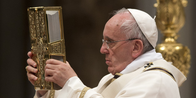 Pope Francis holds the Holy Book as he celebrates an Easter vigil service, in St. Peter's Basilica, at the Vatican, Saturday, April 4, 2015. (AP Photo/Andrew Medichini)