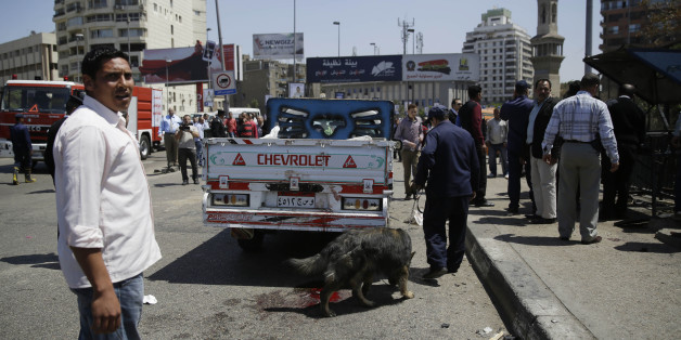 Security personnel use a bomb-sniffing dog at the scene of an explosion that killed at least one person on a bridge over the Nile River, near an upscale neighborhood of Cairo, Egypt, Sunday, April 5, 2015. Attacks mainly targeting Egyptian security forces have spiked since the 2013 military overthrow of Islamist President Mohammed Morsi following massive protests against his divisive rule. (AP Photo/Hassan Ammar)