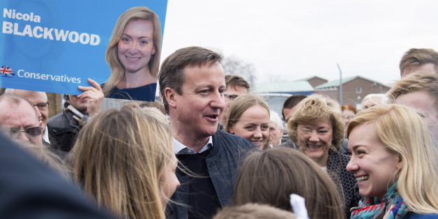 Britain's Prime Minister and Conservative party leader David Cameron, center left, and Conservative party candidate for Oxford West and Abingdon Nicola Blackwood, right, talk to members of the public as they campaign at Abingdon and Witney College in Abingdon, southern England, Saturday, April 4, 2015. Britain's political landscape is at its most fragmented in decades, and polls suggest no party will get a parliamentary majority on May 7. (AP Photo/Leon Neal, Pool)