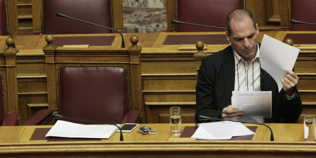 Greek Finance Minister Yanis Varoufakis reads papers during a parliament session in Athens, on Thursday, April 2, 2015. Greece and its international creditors are still struggling to agree on a list of economic reforms that are deemed necessary for the country to unlock emergency funds and stay afloat. (AP Photo/Petros Giannakouris)